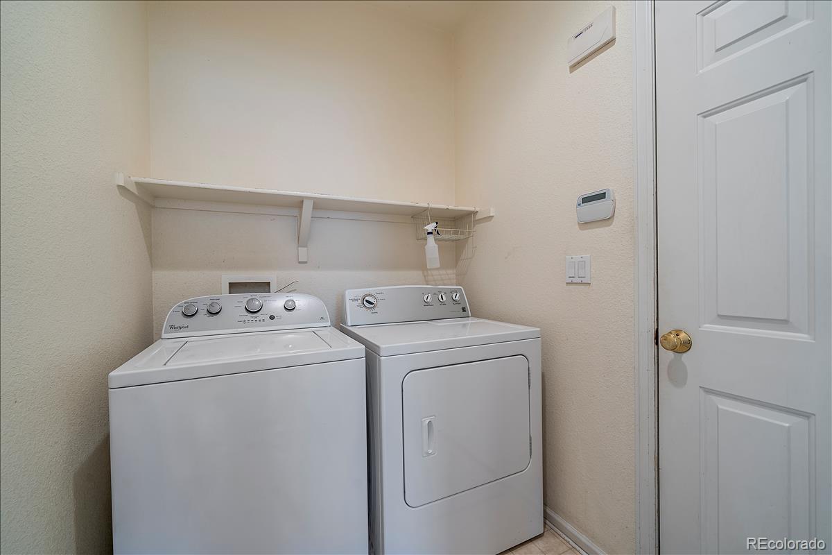 6310 Trailhead Road Highlands Ranch, CO 80130 - Photo 10 of 23 a utility room with dryer and washer