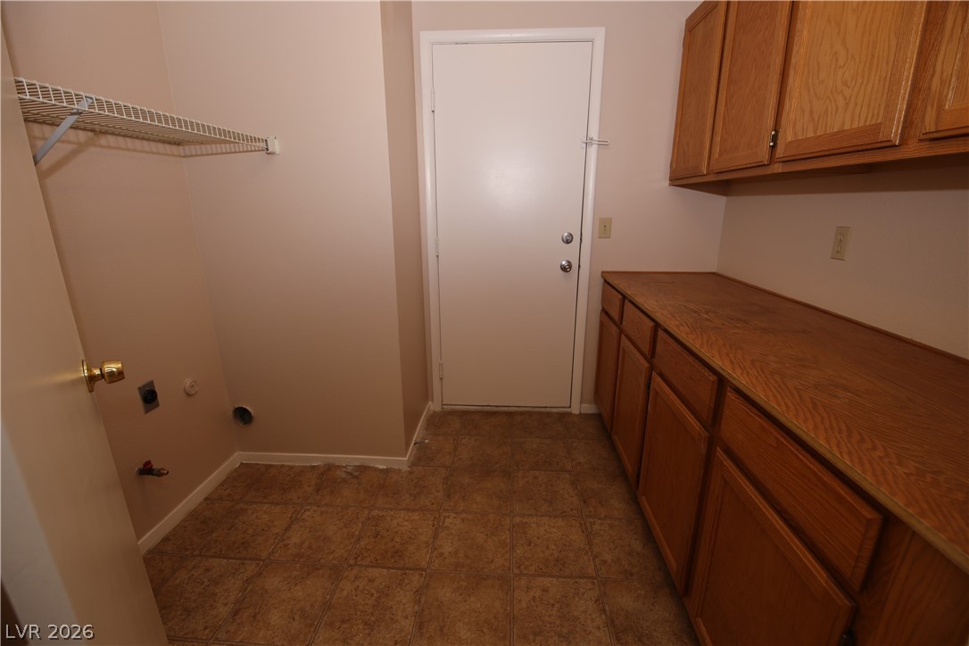 8220 Maplestar Road Las Vegas, NV 89128 - Photo 13 of 29 Functional utility space with ample storage cabinets and convenient laundry hookups.