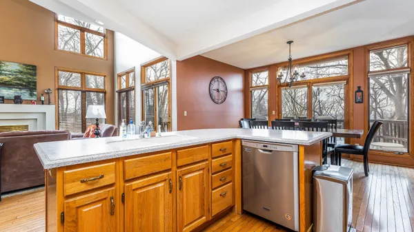 a front view of a house with a yard and large tree