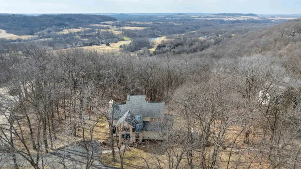 a living room with furniture a flat screen tv and a floor to ceiling window