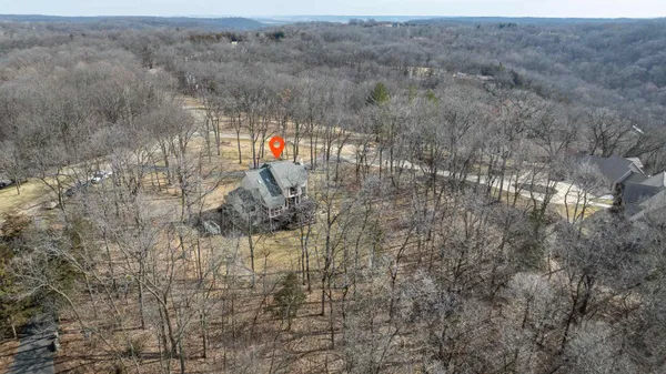 a living room with furniture wooden floor and a floor to ceiling window