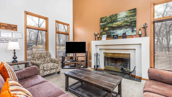 a bedroom with a bed wooden floor and flat screen tv