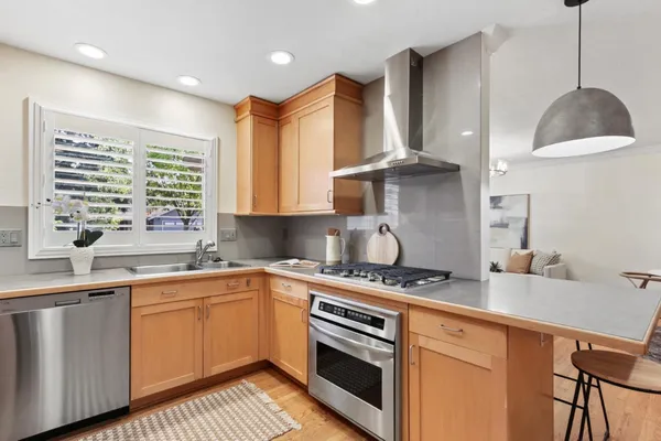 a kitchen with granite countertop a stove and a sink