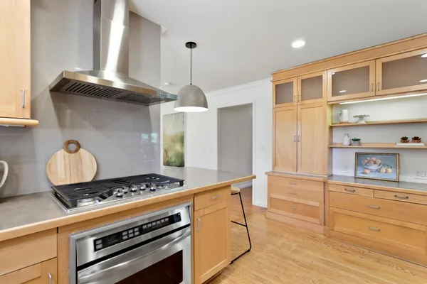 a kitchen with stainless steel appliances granite countertop a refrigerator and a stove