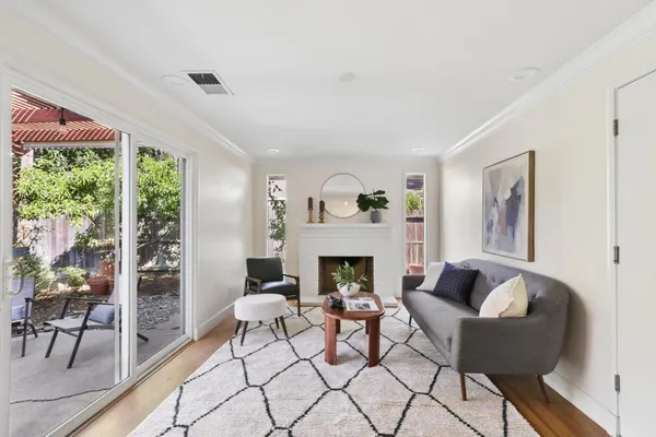 a living room with furniture fireplace and a table
