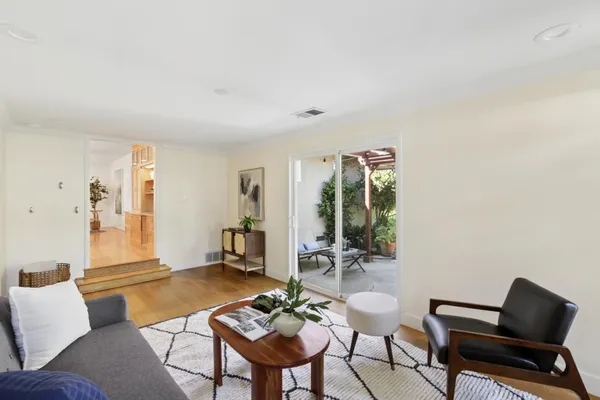 a living room with furniture and wooden floor