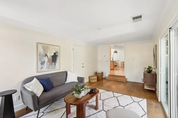 a bedroom with a bed and a painting on the wall