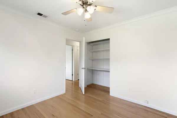 a spacious bathroom with a granite countertop sink a toilet and a shower