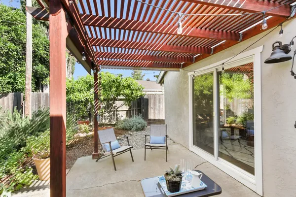 a view of a patio with table and chairs and potted plants