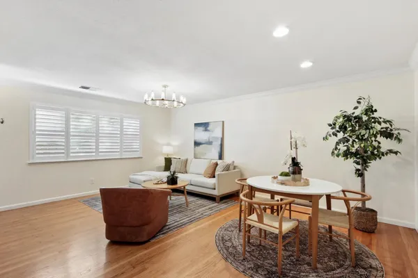 a living room with furniture a window and a mirror