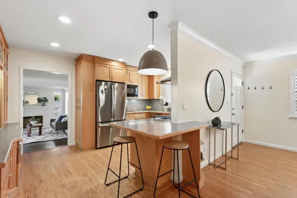 a kitchen with stainless steel appliances a refrigerator sink and microwave