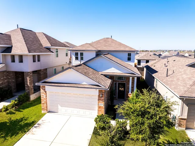 a aerial view of a house with a yard