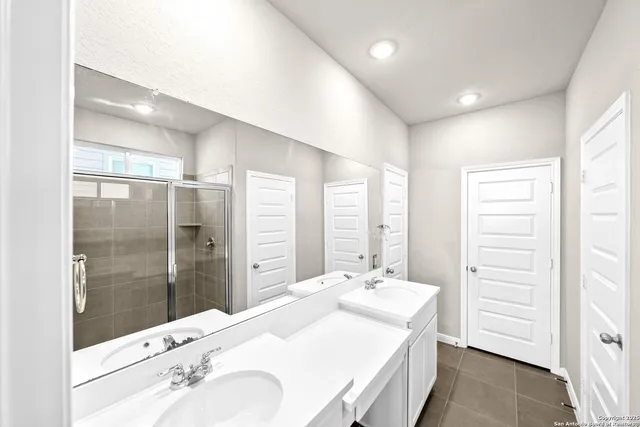 a bathroom with a glass shower door