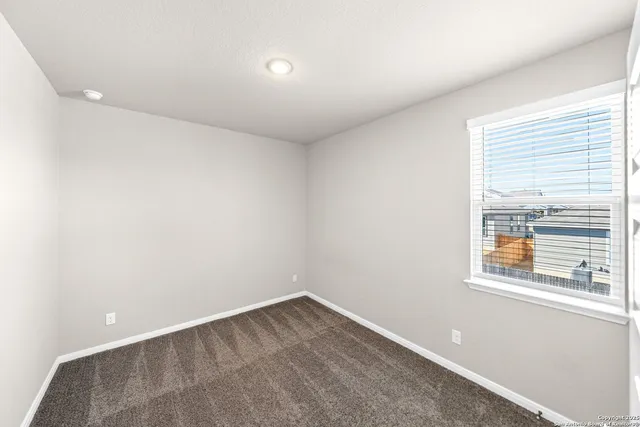 a bedroom with a bed and a potted plant