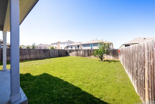 a view of a house with a yard and sitting area