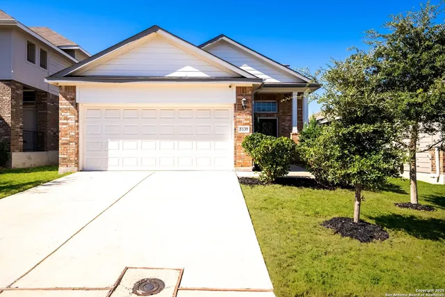 a view of a hallway with wooden floor and windows