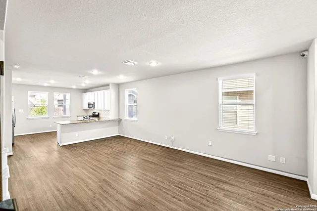 a living room with furniture wooden floor and a flat screen tv