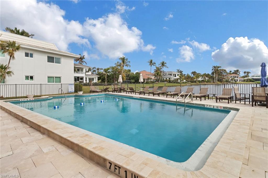 4150 Crayton Road, Unit B3 Naples, FL 34103 - Photo 16 of 19 a view of a swimming pool with a lake view
