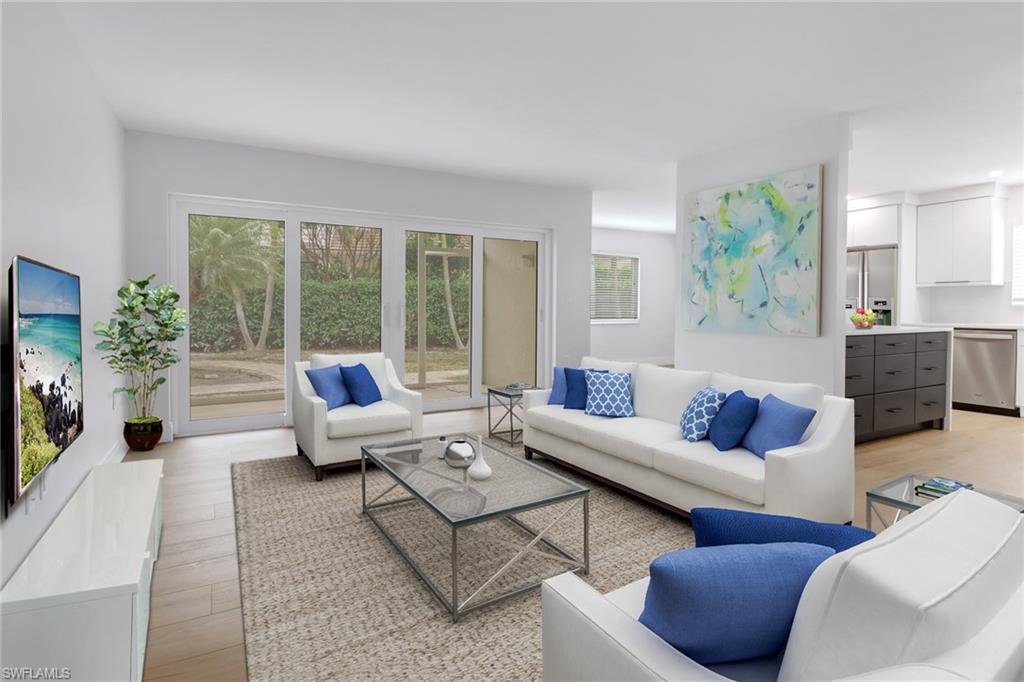 4150 Crayton Road, Unit B3 Naples, FL 34103 - Photo 2 of 19 a living room with furniture and a flat screen tv