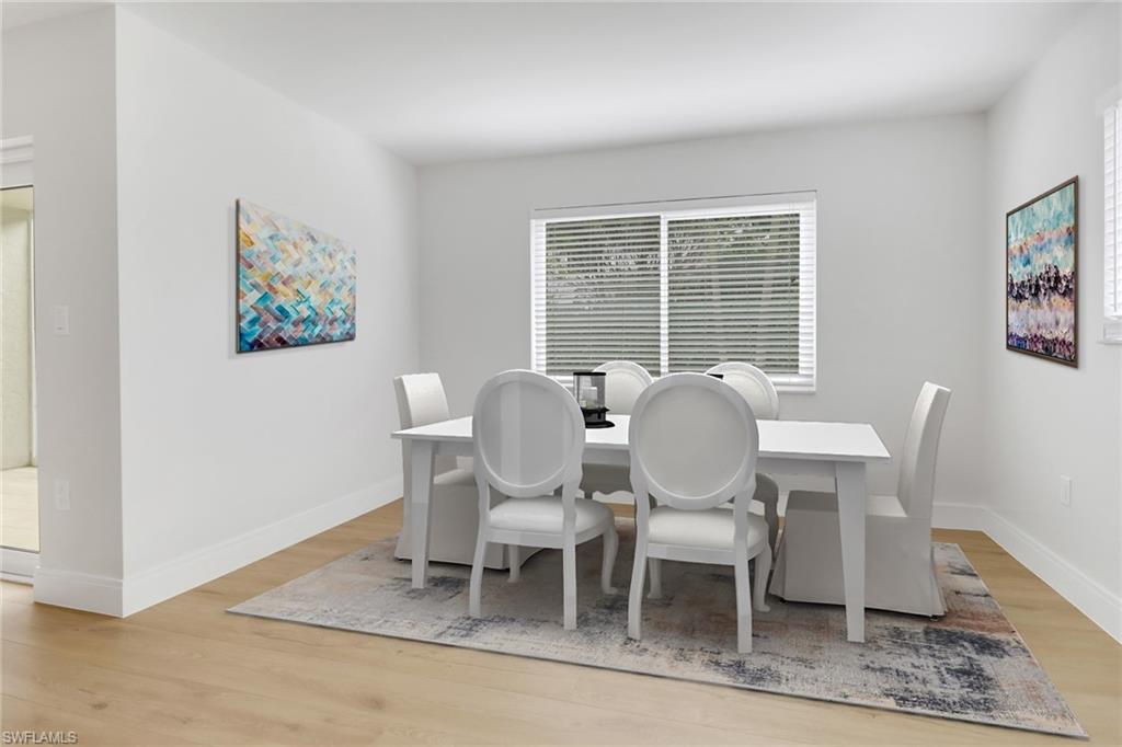 4150 Crayton Road, Unit B3 Naples, FL 34103 - Photo 7 of 19 a view of a dining room with furniture window and wooden floor