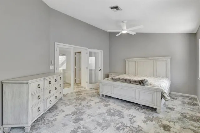 a bedroom with a bed and a large window