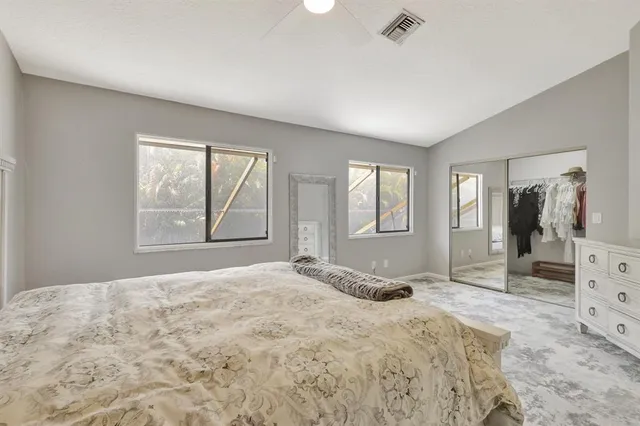 a spacious bedroom with a bed and a window