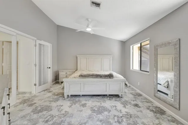 a bathroom with a granite countertop toilet sink and mirror