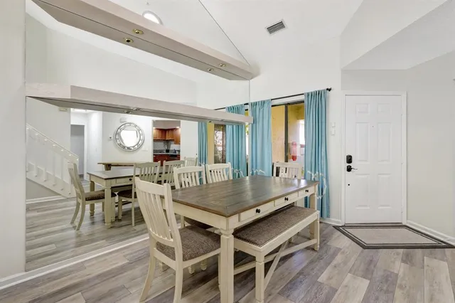 a view of a hallway with furniture and a large window
