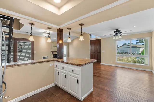 a view of a kitchen with a sink and wooden floor