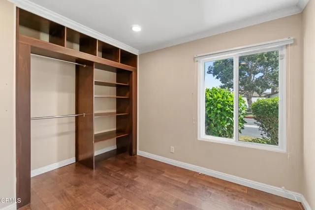 a view of an empty room with a window and closet