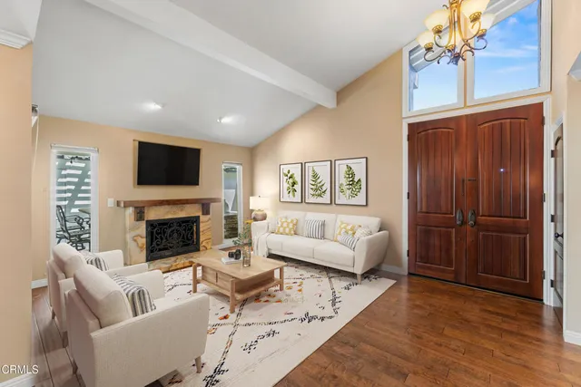 a living room with furniture a fireplace and a flat screen tv