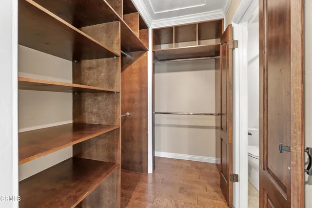 a view of walk in closet with empty racks