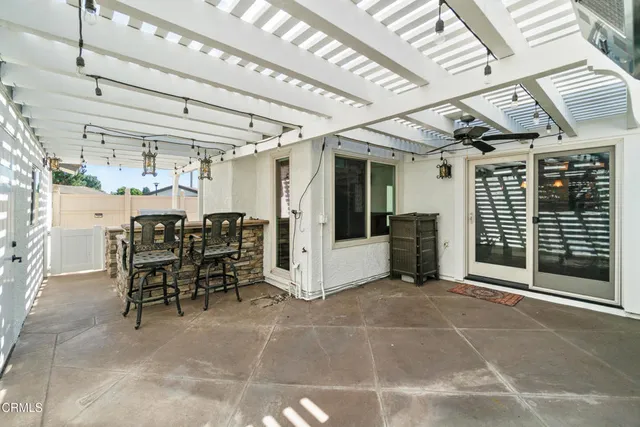 a view of a porch with table and chairs