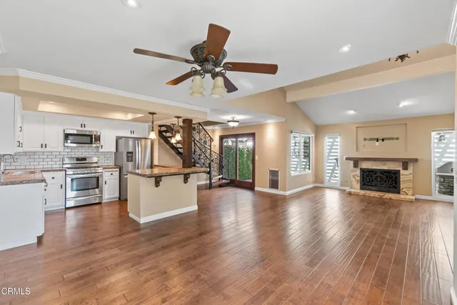 a view of a kitchen and window with wooden floor