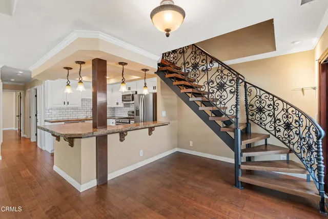 a view of entryway and hall with wooden floor