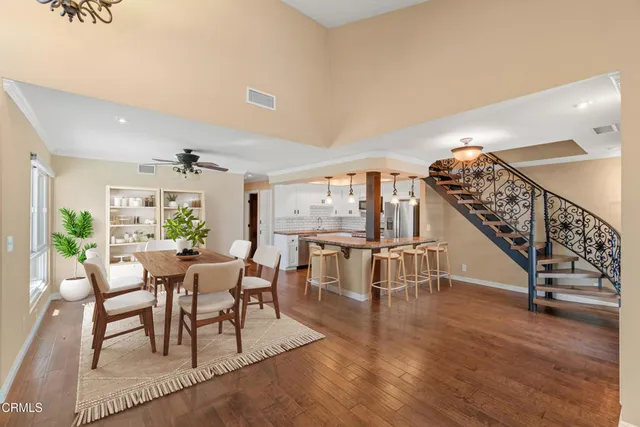 a view of a livingroom with furniture wooden floor and windows