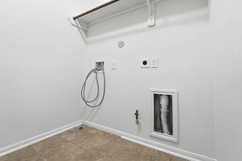 a room with white cabinets and a window