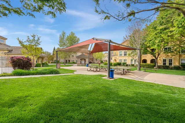 a view of patio with a table and chairs under an umbrella