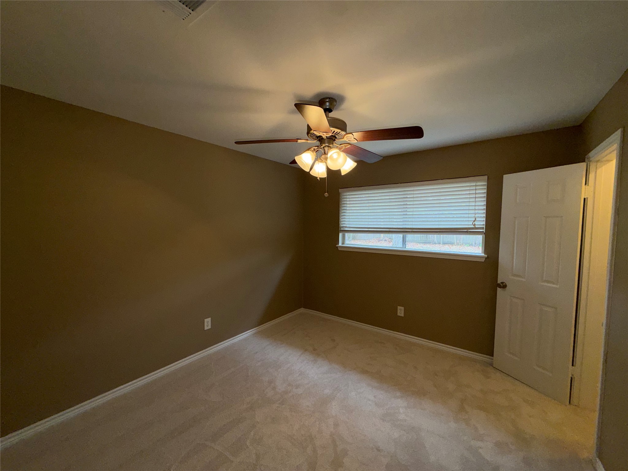 7306 Troulon Drive Houston, TX 77074 - Photo 13 of 16 a view of a chandelier fan and wooden floor
