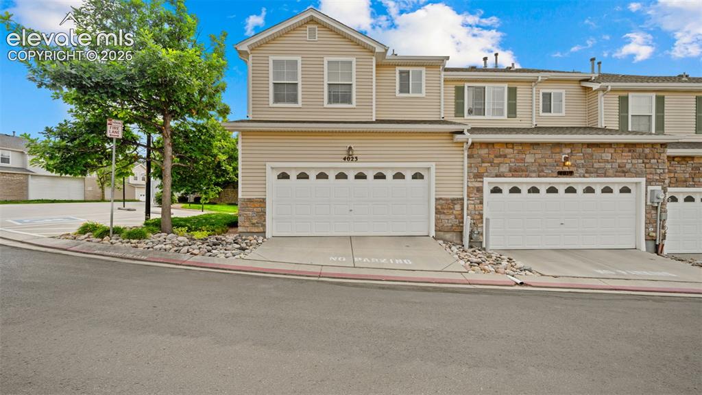 4023 Diamond Ridge View Colorado Springs, CO 80918 - Photo 4 of 31 a front view of a house with a yard and garage