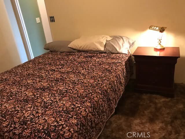 3302 Windy Hollow Road Mariposa, CA 95338 - Photo 4 of 13 a bedroom with a bed and a potted plant