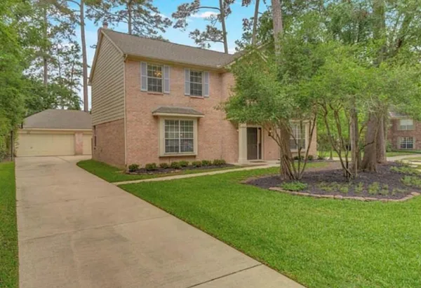 a view of a house with a backyard