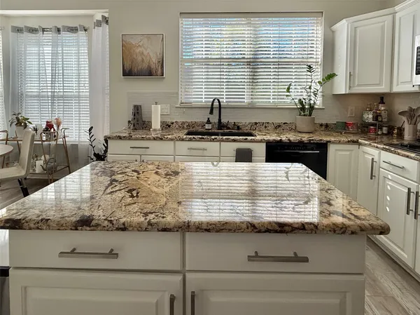 a kitchen with a stove a sink and a refrigerator
