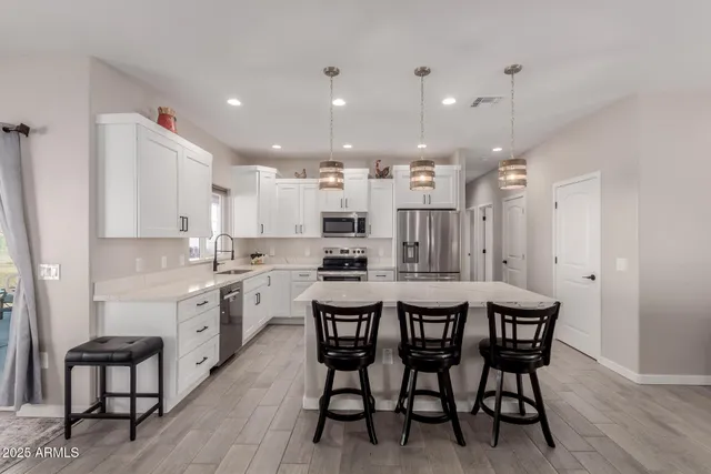 a large kitchen with a table and chairs