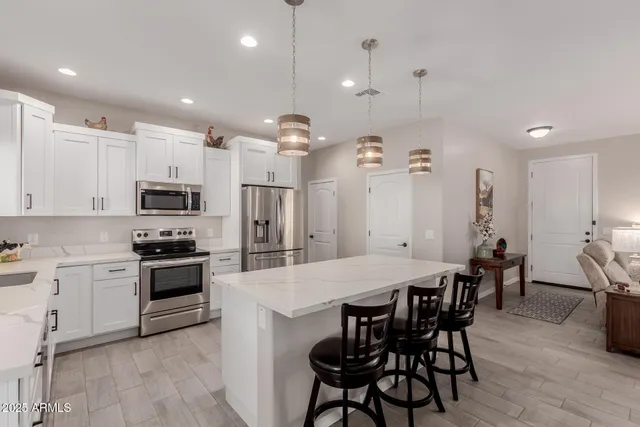 a large kitchen with a table and chairs