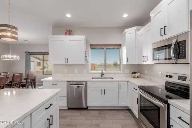 a kitchen with a sink stove and cabinets