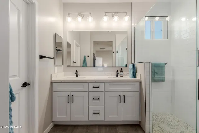 a bathroom with a double vanity sink and mirror