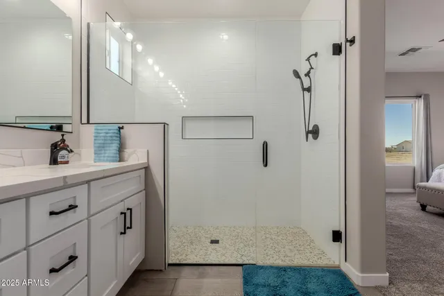 a bathroom with a shower sink and mirror
