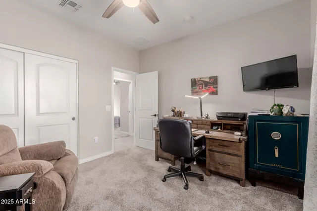 a view of a livingroom with workspace and a window