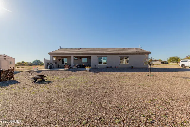 a view of a house with a yard and sitting area